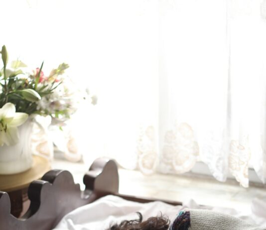 수면의 질 향상을 위한 생활 습관 woman sleeping on bed beside book