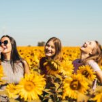 여성 건강관리, 일상에서 시작하는 똑똑한 습관 만들기 woman in white and black striped shirt standing on yellow sunflower field during daytime