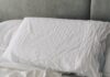건강한 수면 루틴, 일상의 작은 변화가 삶을 바꾼다 A rumpled white duvet and pillows on a bed.