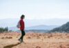 걷기 운동, 일상 속에서 자연스럽게 실천하는 건강 습관 a man with a backpack walking across a dry grass covered field