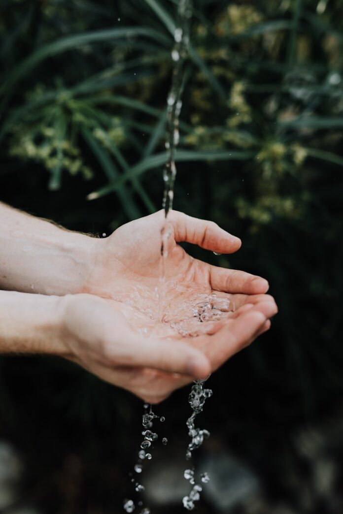 Photo by Austin Kehmeier water drop on persons hand